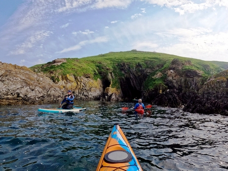 Kayaks and paddleboard at sea
